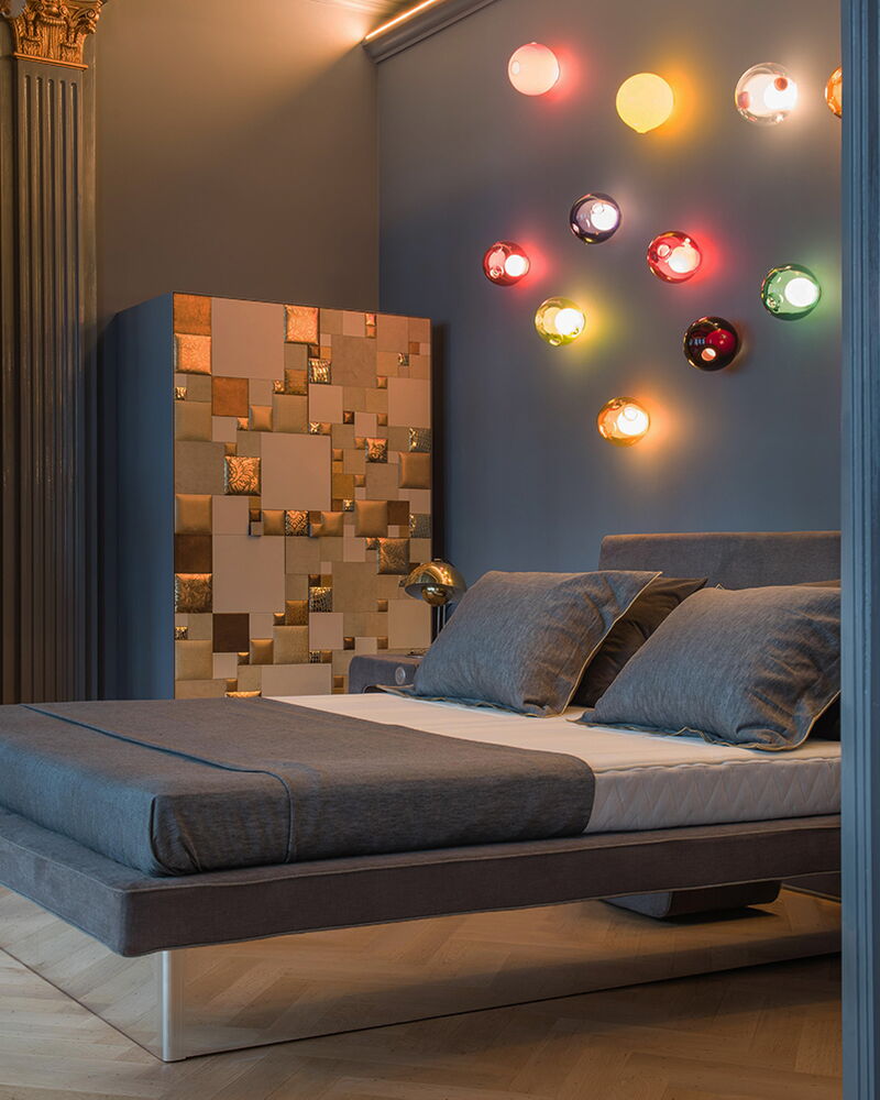 Wasserbett mit grauem Bezug und Holzfüßen