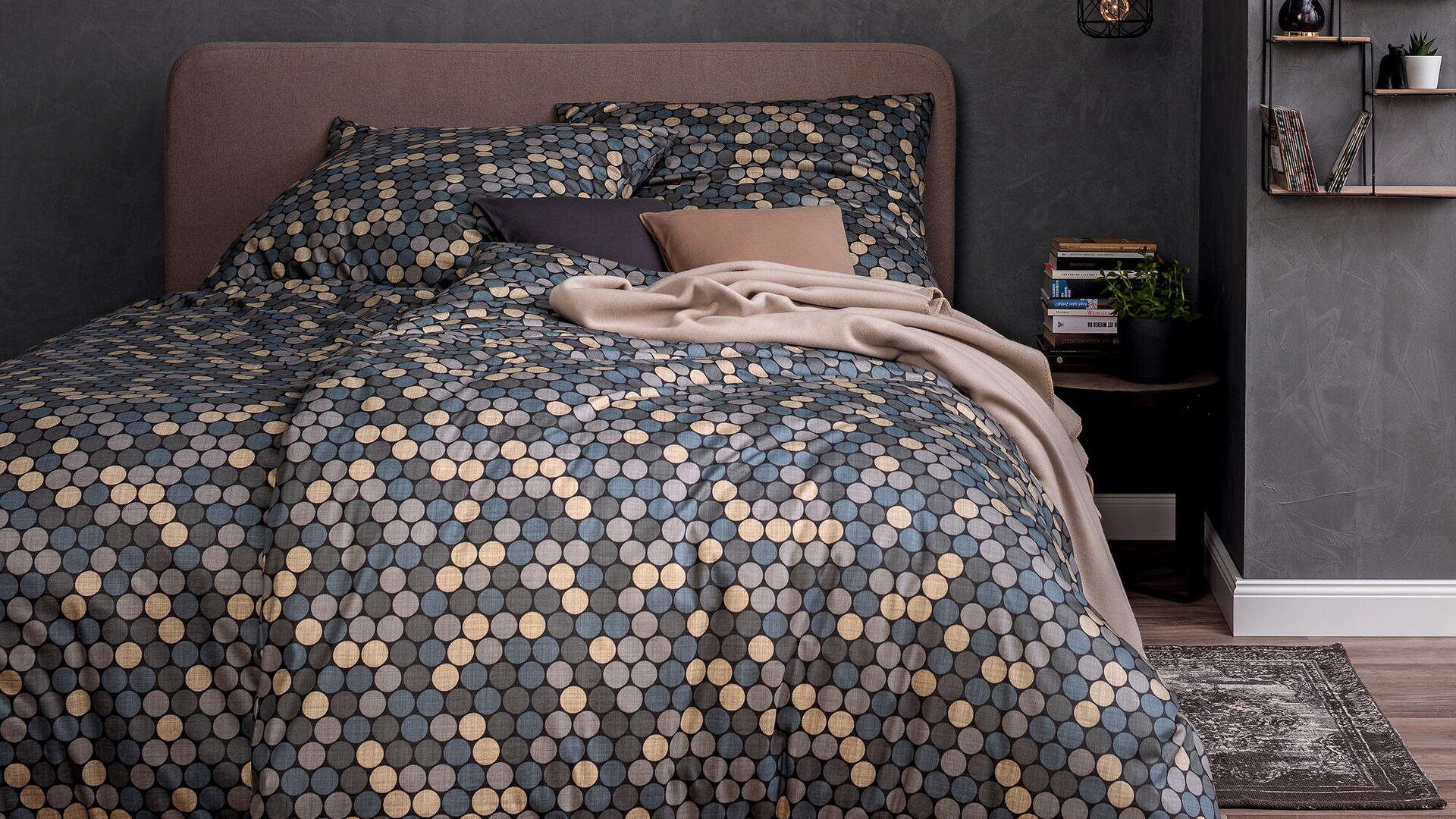 Bettwäsche mit grauem Punktmuster auf einem Boxspringbett